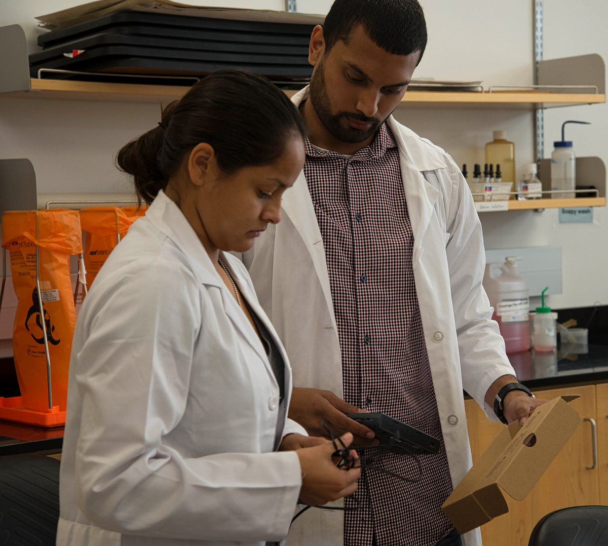 A professor in Human Physiology helps a student